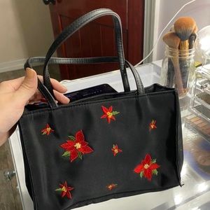 Black purse with red flowers